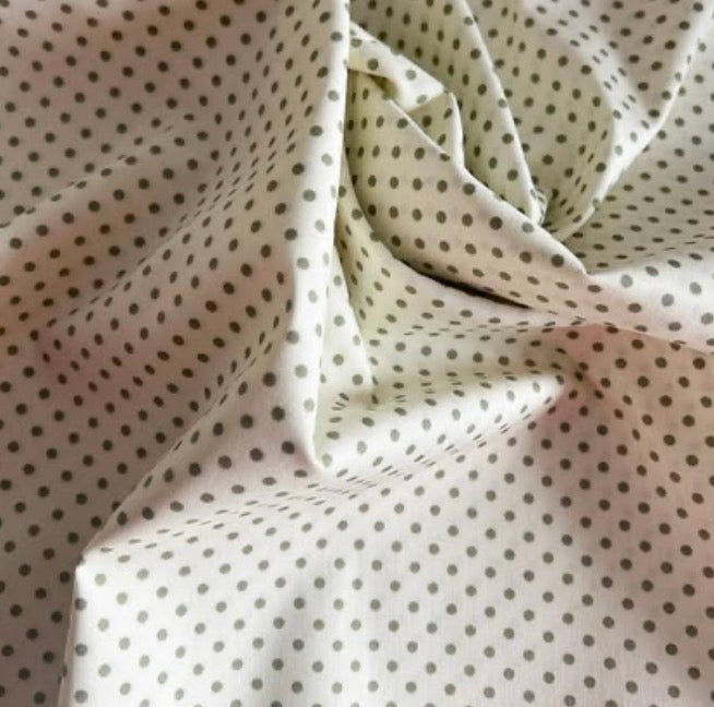 Cotton  poplin fabric Cream with 3mm green spots by Rose & Hubble